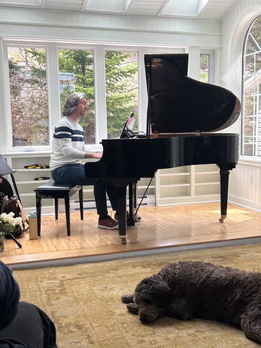 Musician Evan Smith performing a small concert in the Archangel Studios room.